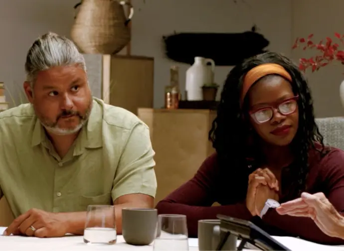 A photo of a man and a woman listening intently.